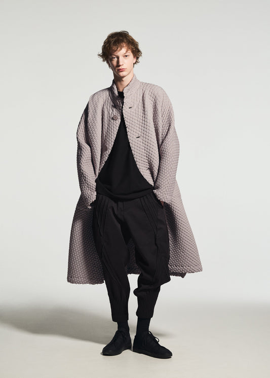 A model wears the A-POC ABLE ISSEY MIYAKE TYPE-O 024 coat.