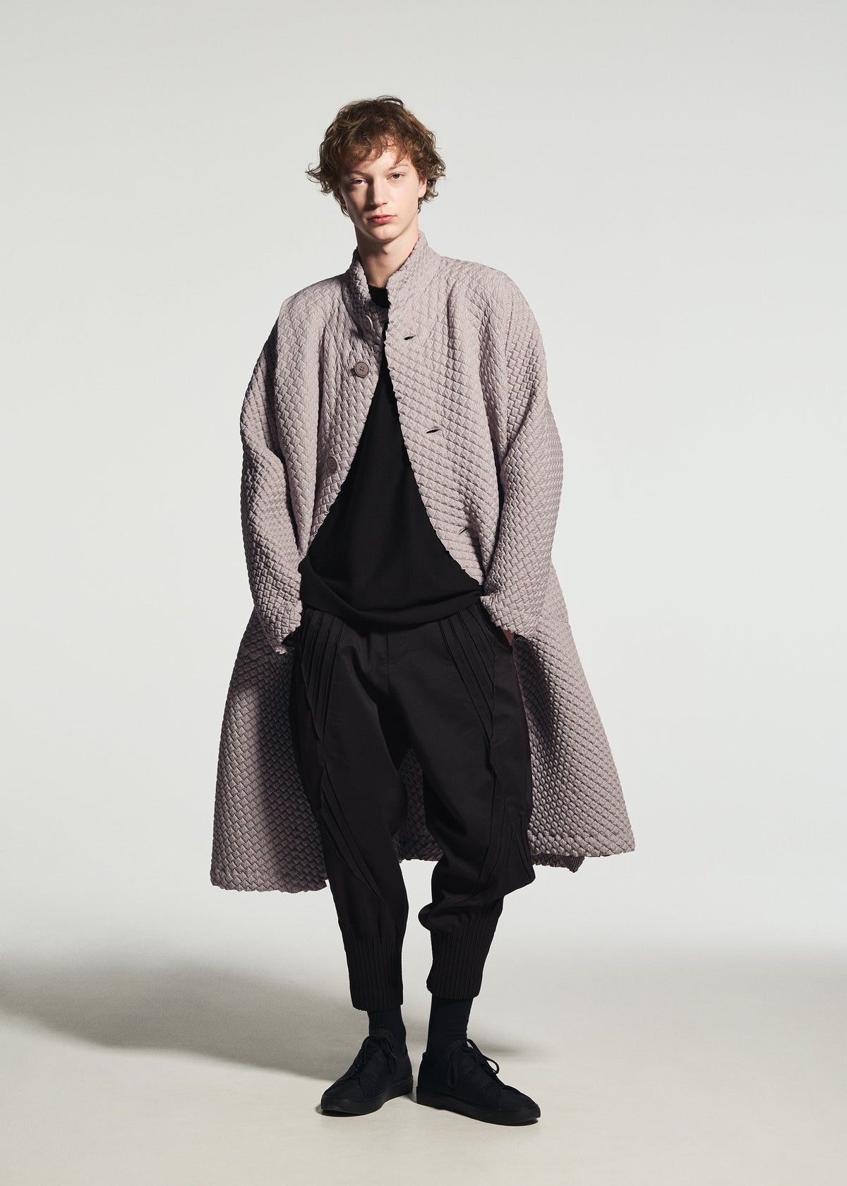 A model wears the A-POC ABLE ISSEY MIYAKE TYPE-O 024 coat.