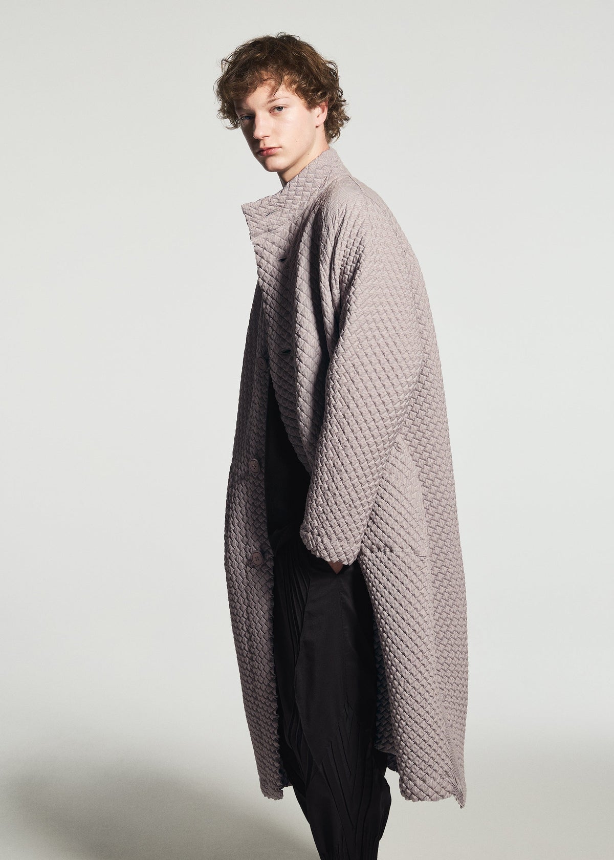 A model wears the A-POC ABLE ISSEY MIYAKE TYPE-O 024 coat.