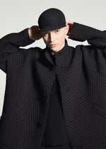 A model wears the A-POC ABLE ISSEY MIYAKE TYPE-O 024 coat.