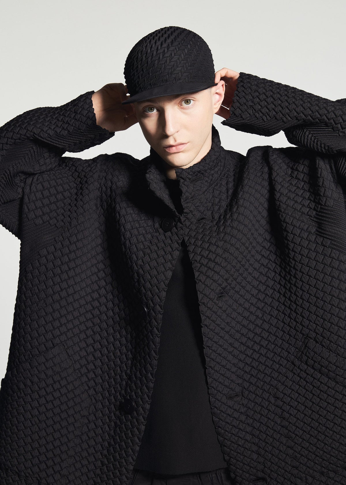 A model wears the A-POC ABLE ISSEY MIYAKE TYPE-O 024 coat.