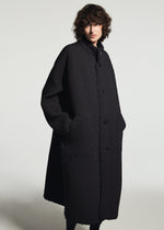 A model wears the A-POC ABLE ISSEY MIYAKE TYPE-O 024 coat.
