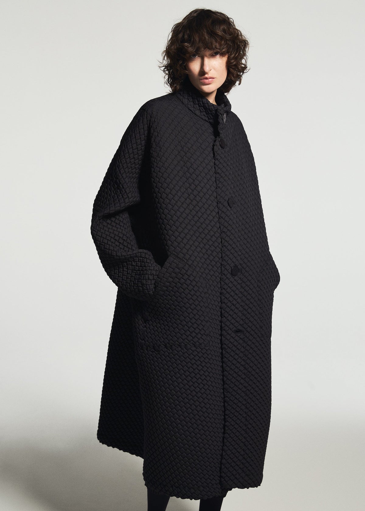 A model wears the A-POC ABLE ISSEY MIYAKE TYPE-O 024 coat.
