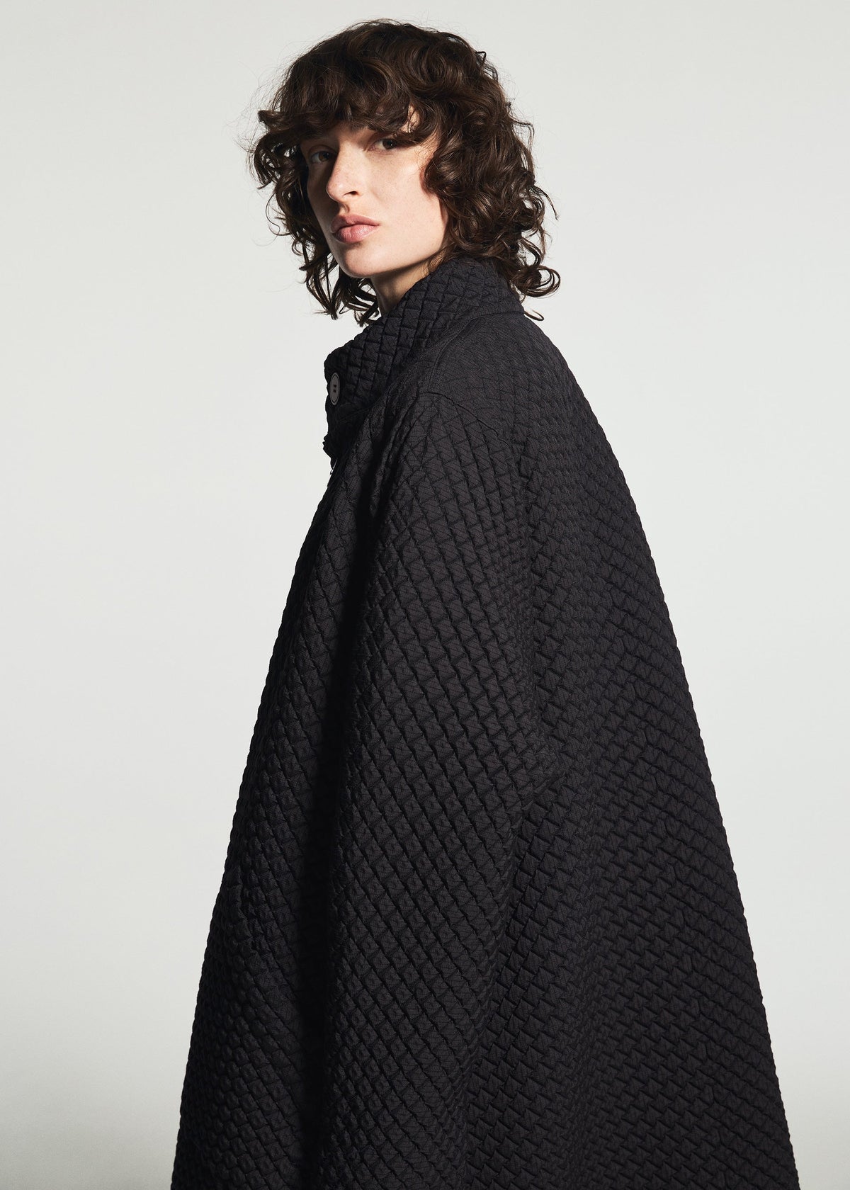 A model wears the A-POC ABLE ISSEY MIYAKE TYPE-O 024 coat.