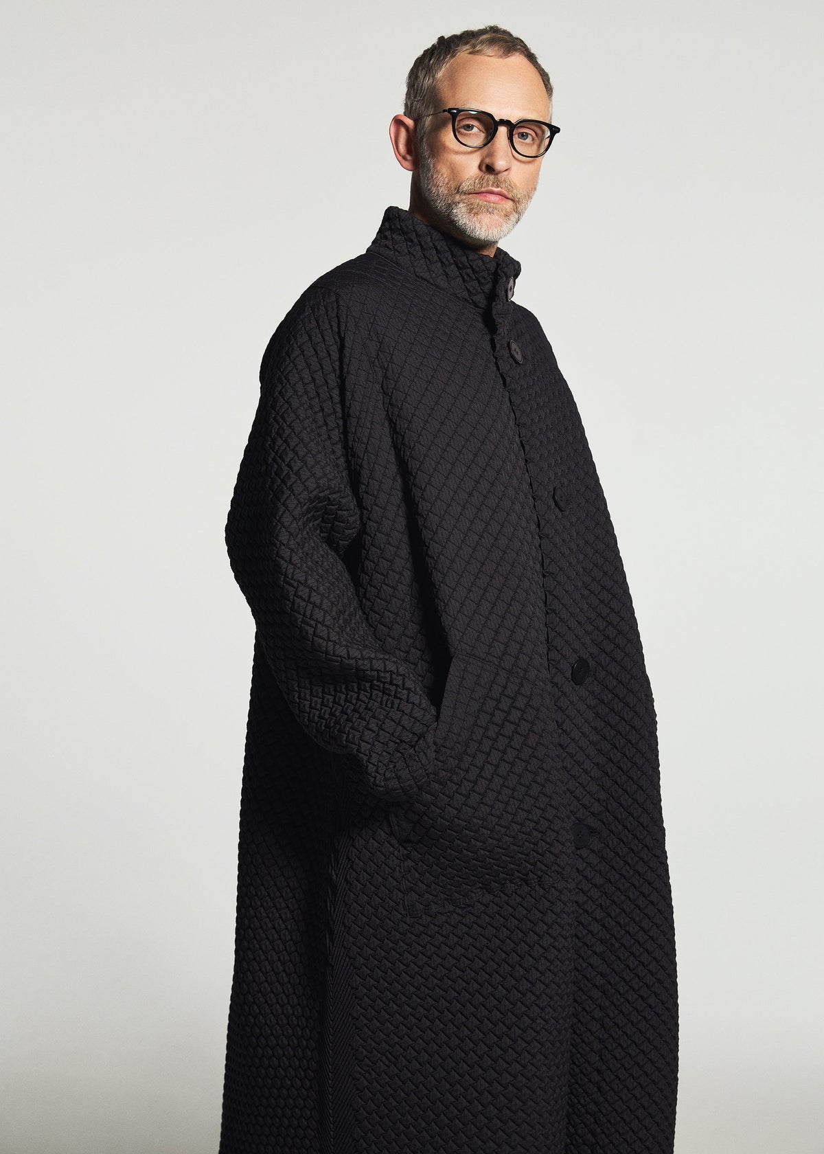 A model wears the A-POC ABLE ISSEY MIYAKE TYPE-O 024 coat.