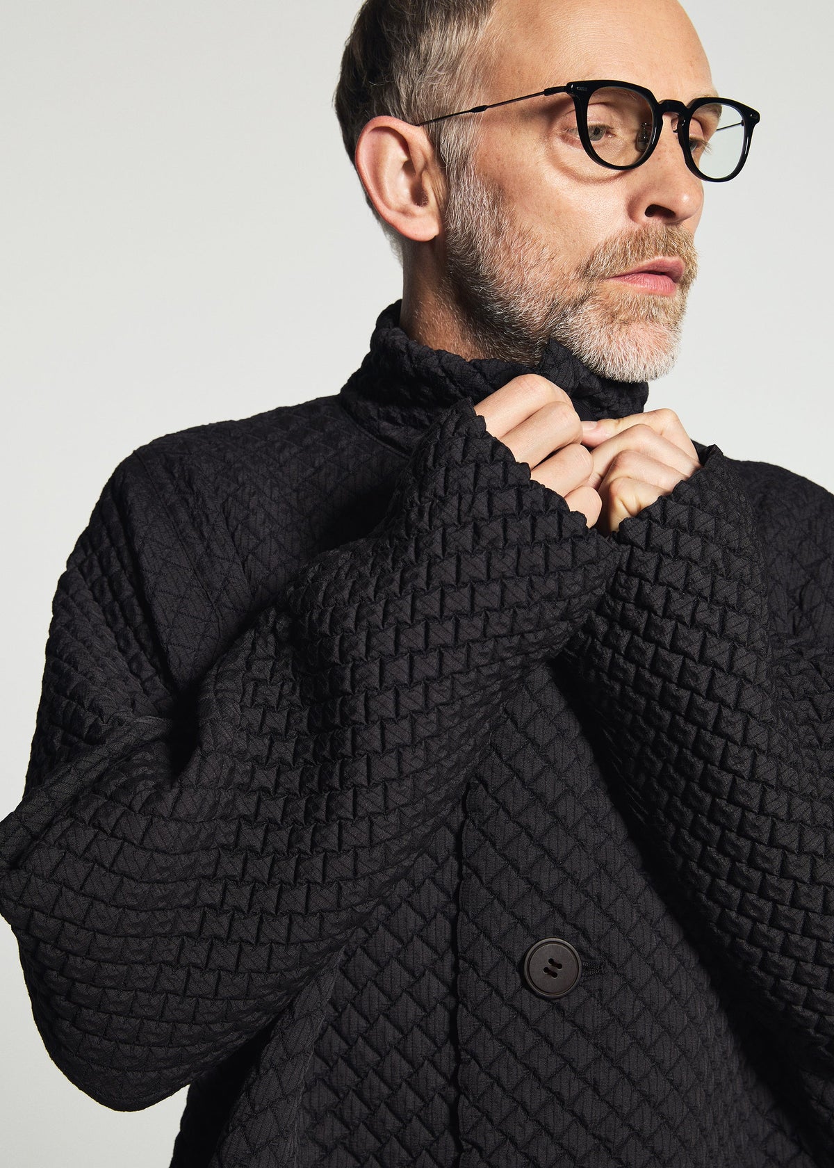 A model wears the A-POC ABLE ISSEY MIYAKE TYPE-O 024 coat.
