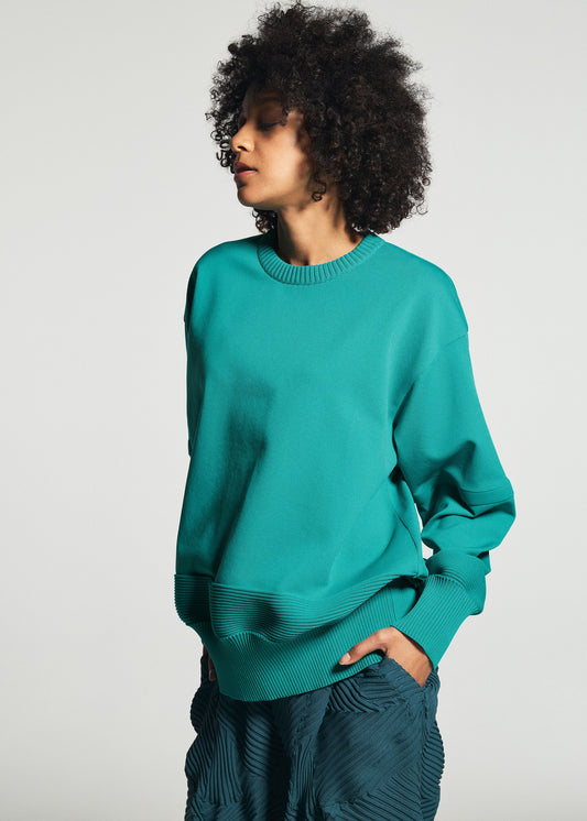 A model wears the A-POC ABLE ISSEY MIYAKE TYPE-K 009 top.