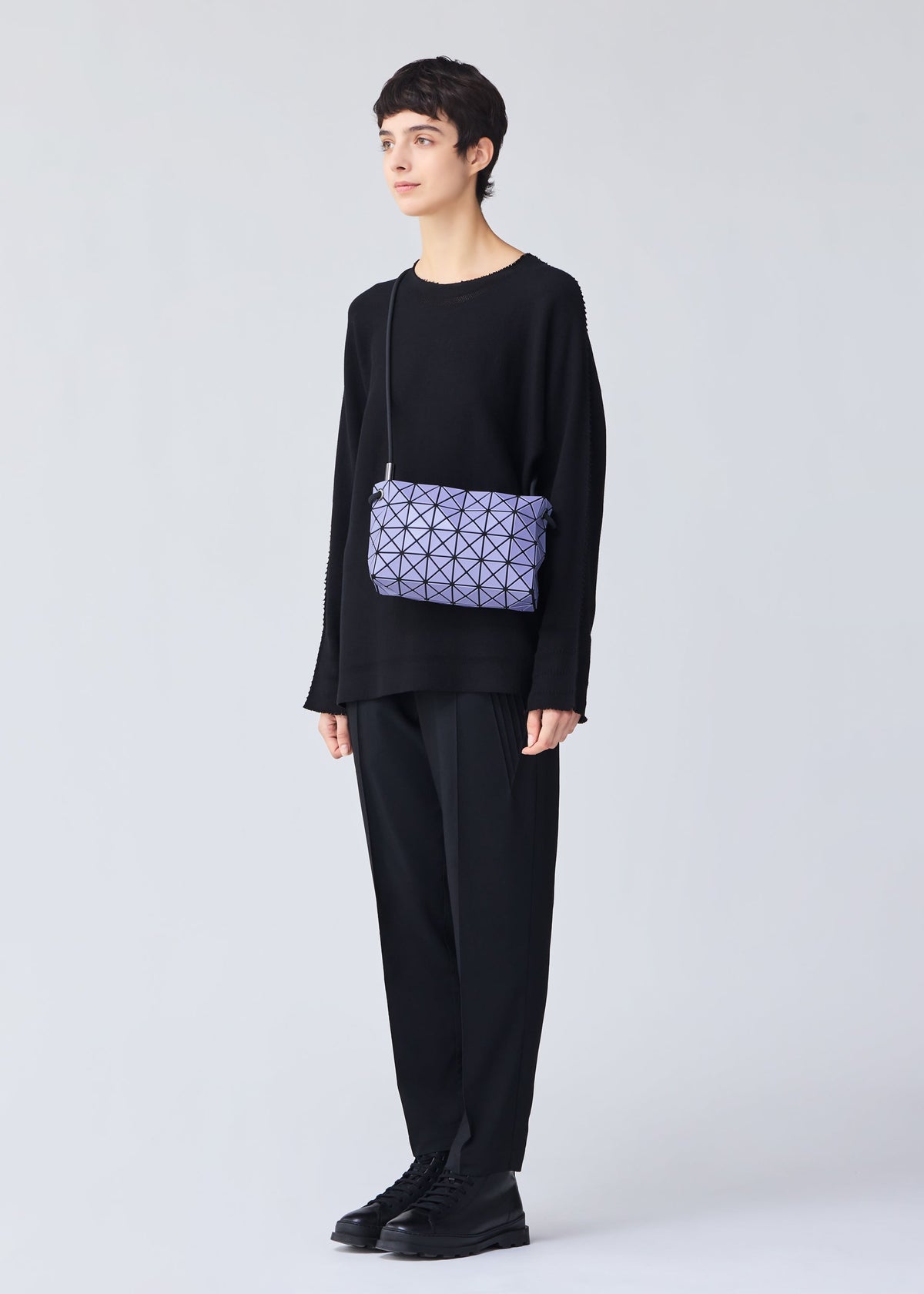 A model wears the Bao Bao Issey Miyake LOOP MATTE shoulder bag.