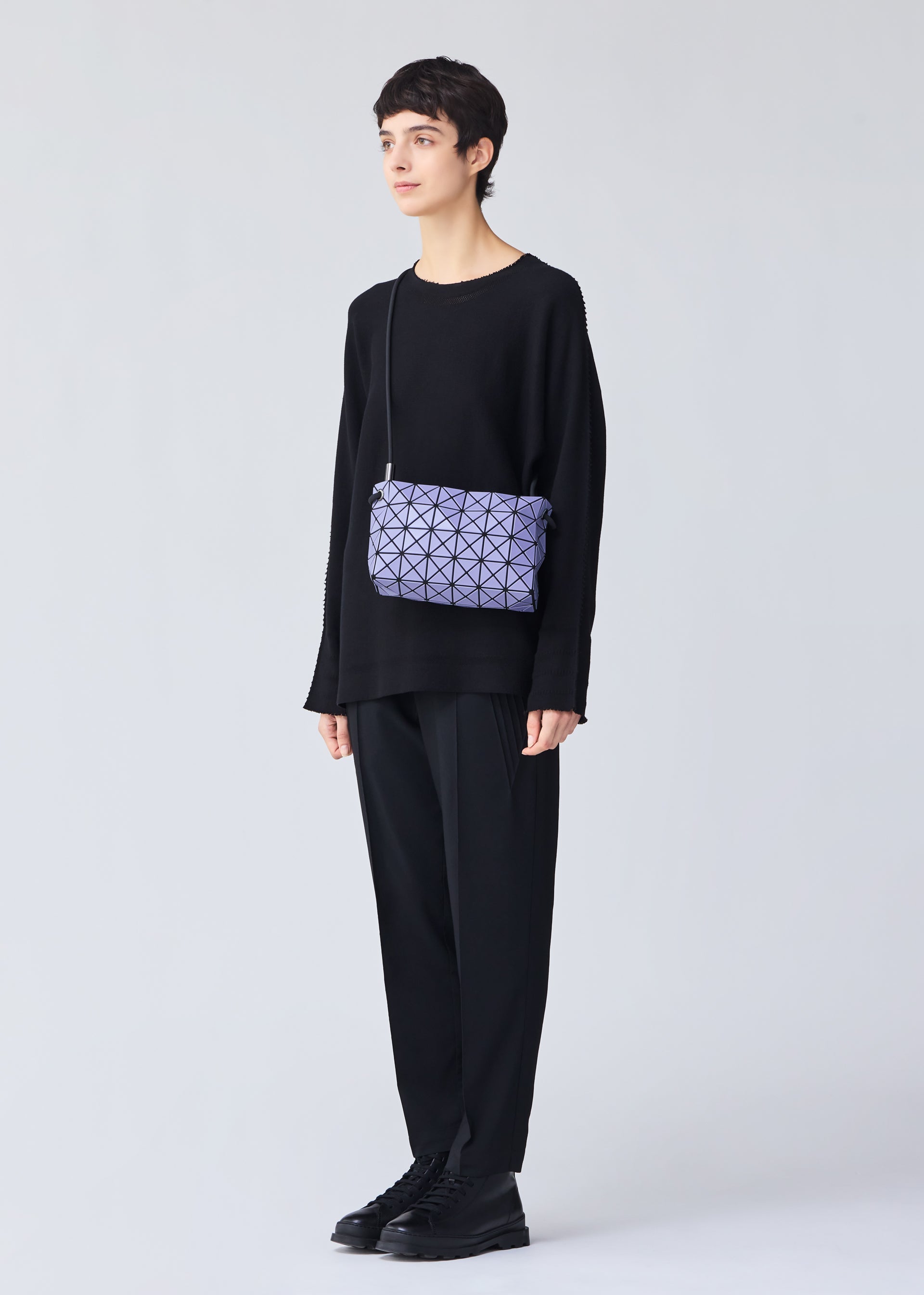 A model wears the Bao Bao Issey Miyake LOOP MATTE shoulder bag.