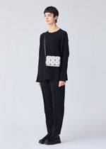 A model wears the BAO BAO ISSEY MIYAKE CUBOID shoulder bag.