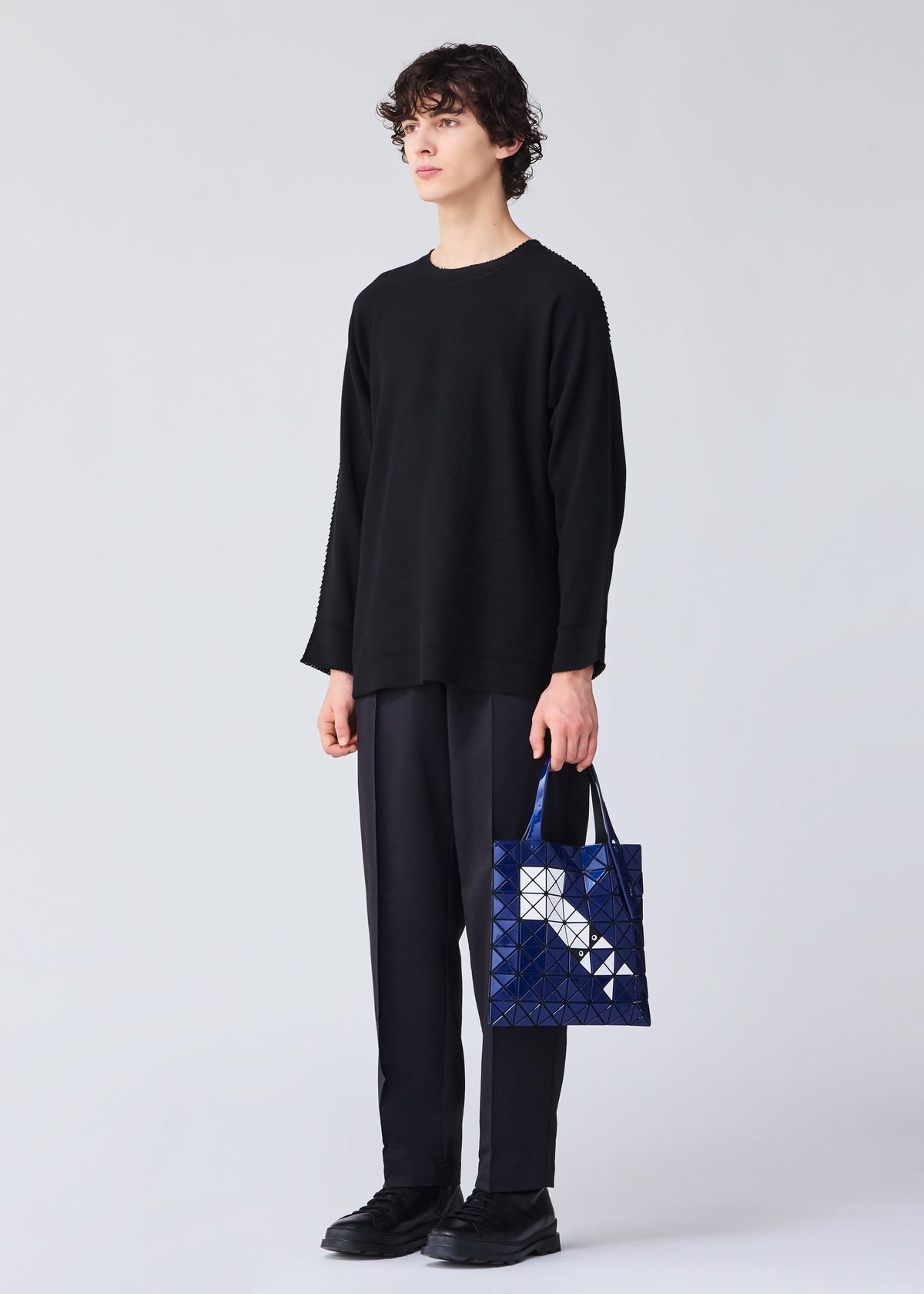 A model wears the Bao Bao Issey Miyake WONDER tote bag.