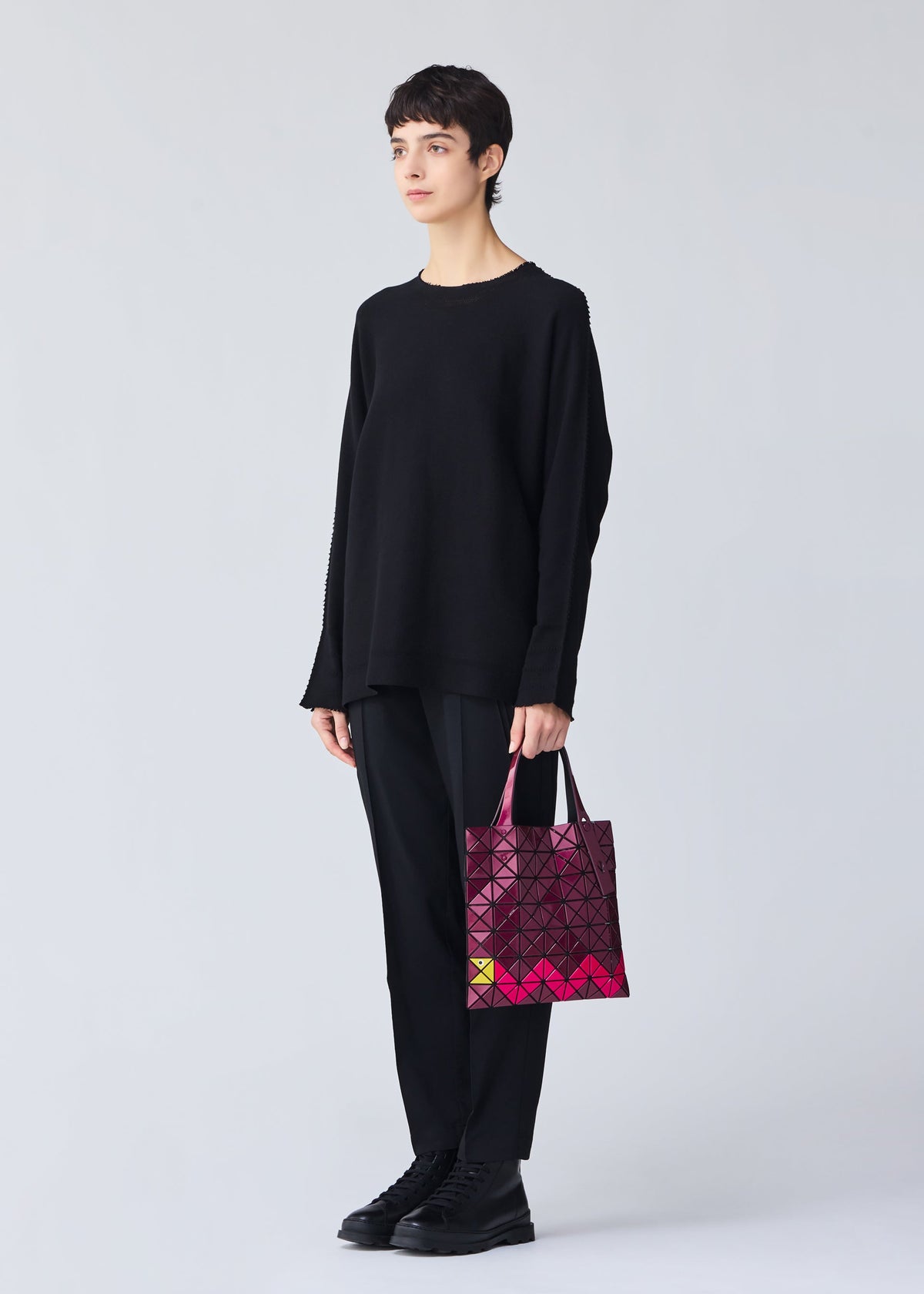 A model wears the Bao Bao Issey Miyake WONDER tote bag.
