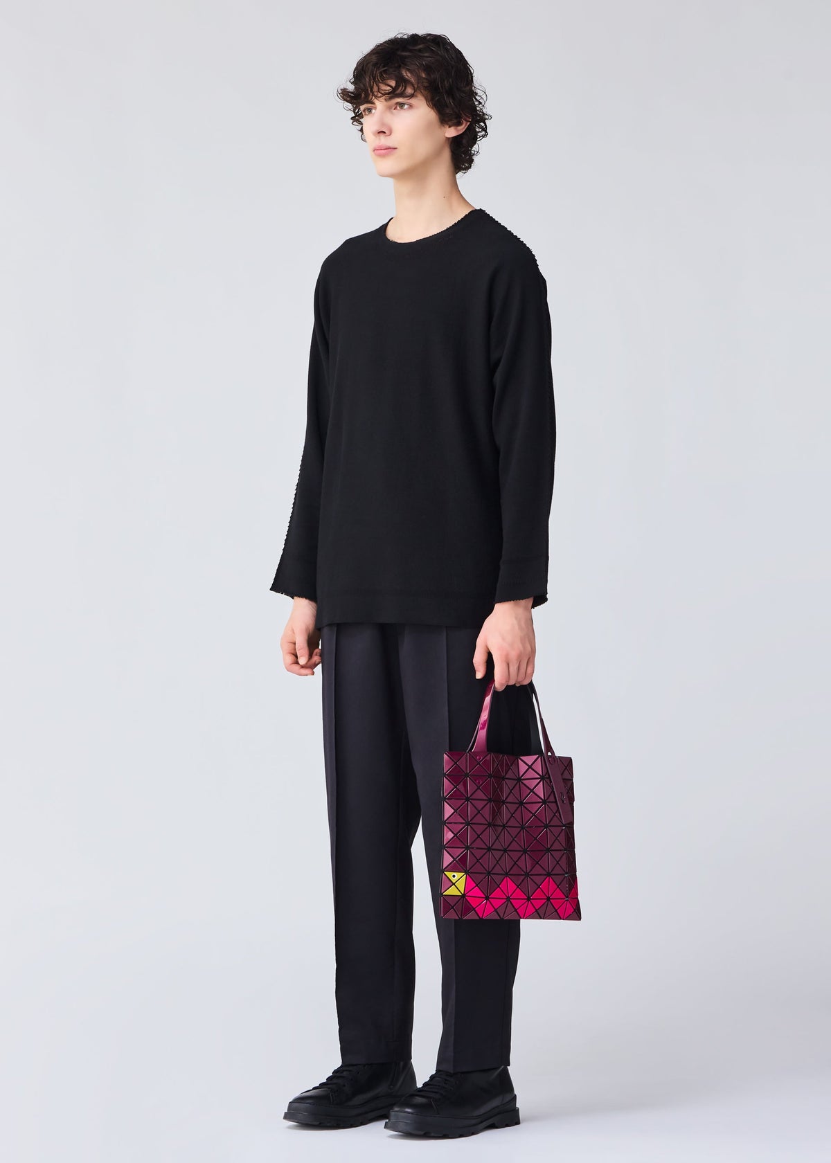 A model wears the Bao Bao Issey Miyake WONDER tote bag.