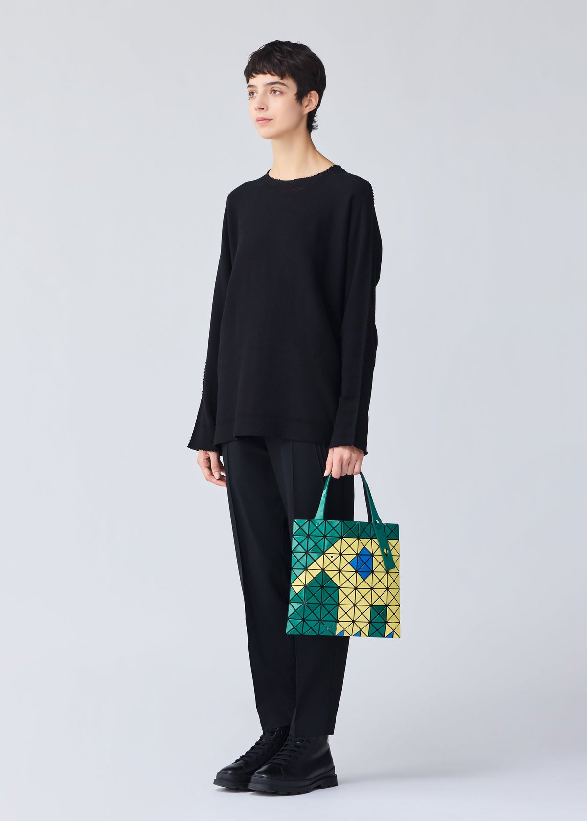 A model wears the Bao Bao Issey Miyake WONDER tote bag.