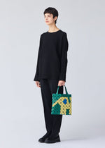 A model wears the Bao Bao Issey Miyake WONDER tote bag.