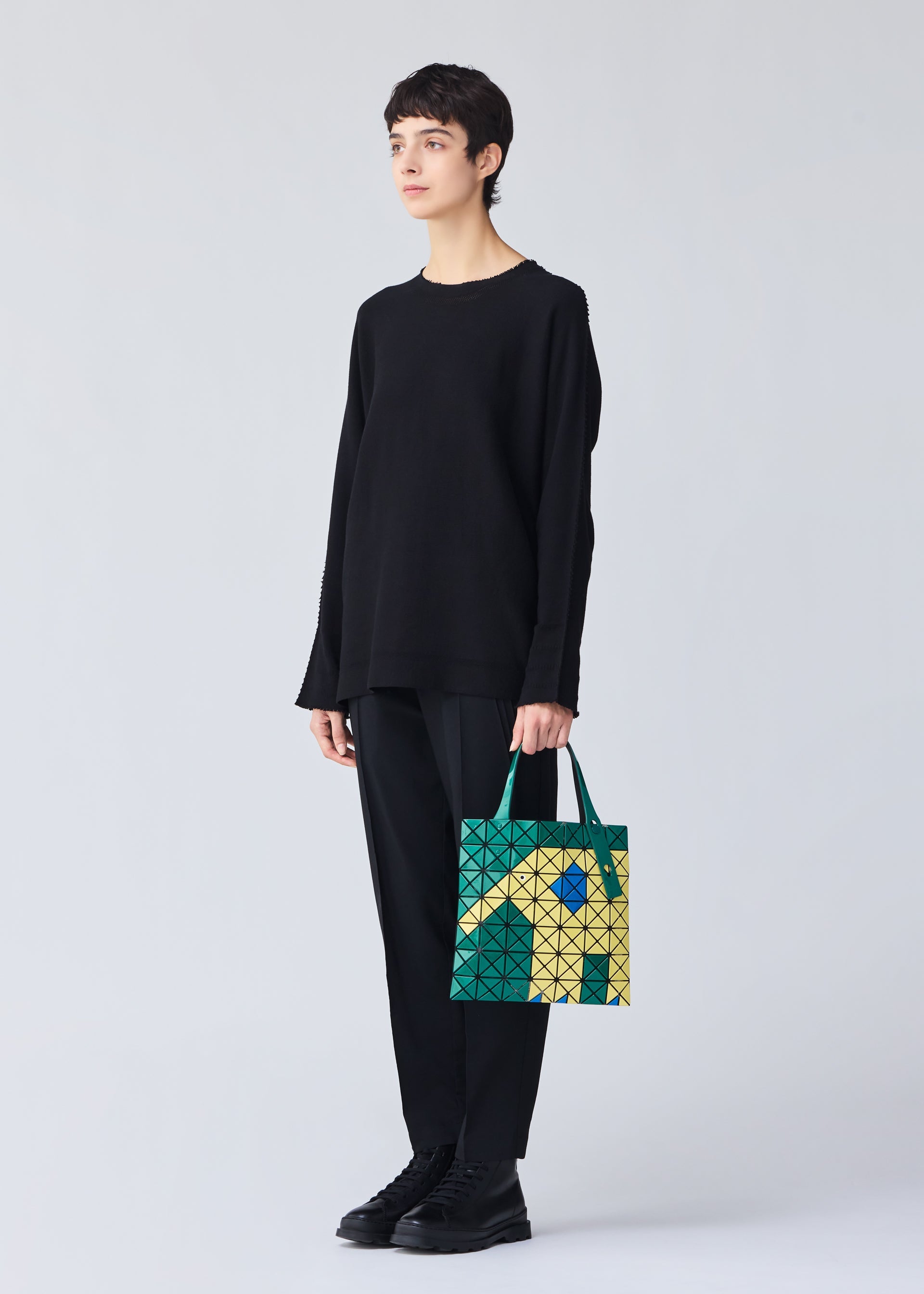 A model wears the Bao Bao Issey Miyake WONDER tote bag.