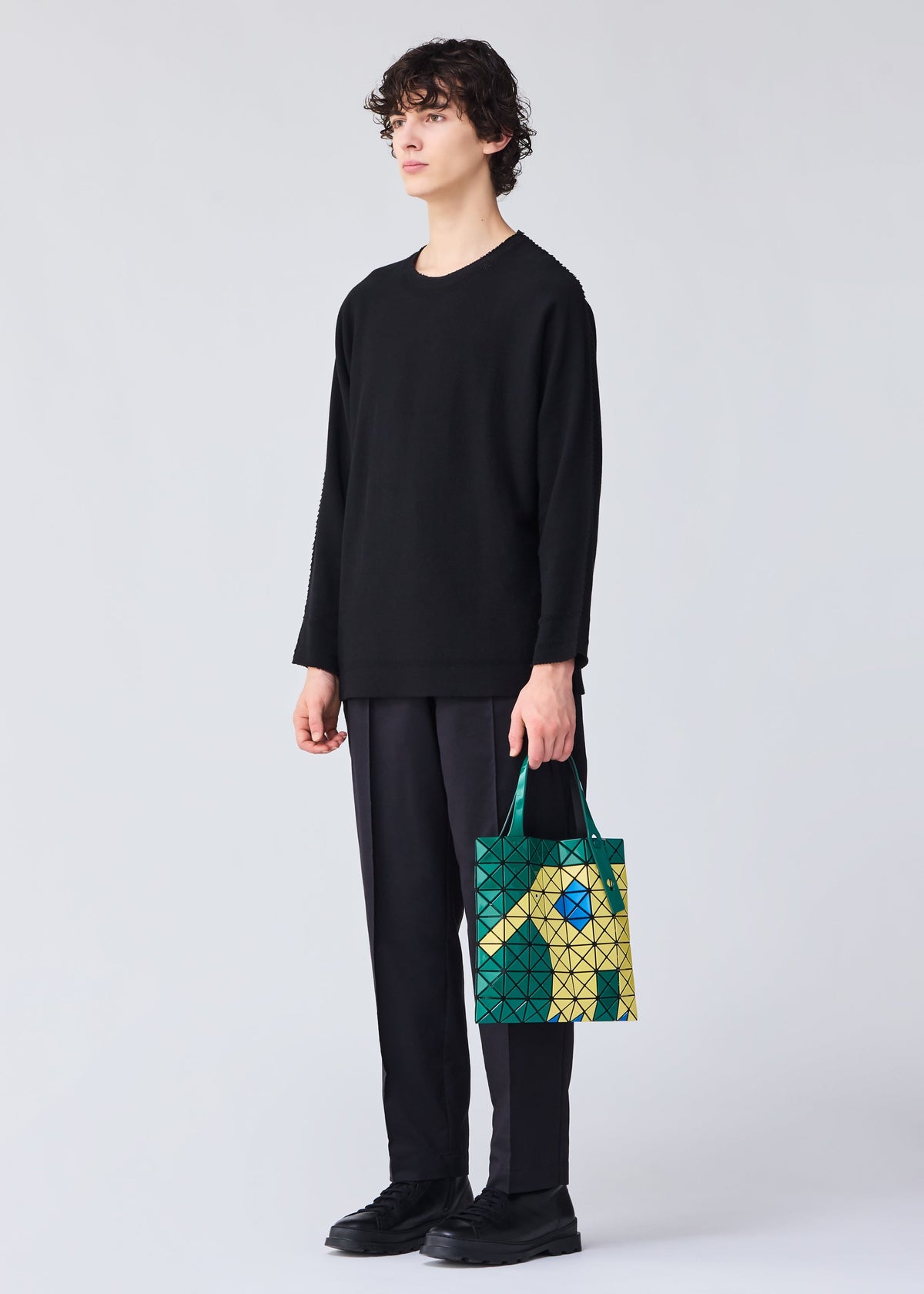 A model wears the Bao Bao Issey Miyake WONDER tote bag.
