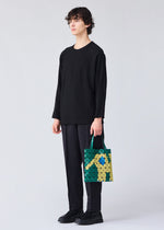 A model wears the Bao Bao Issey Miyake WONDER tote bag.