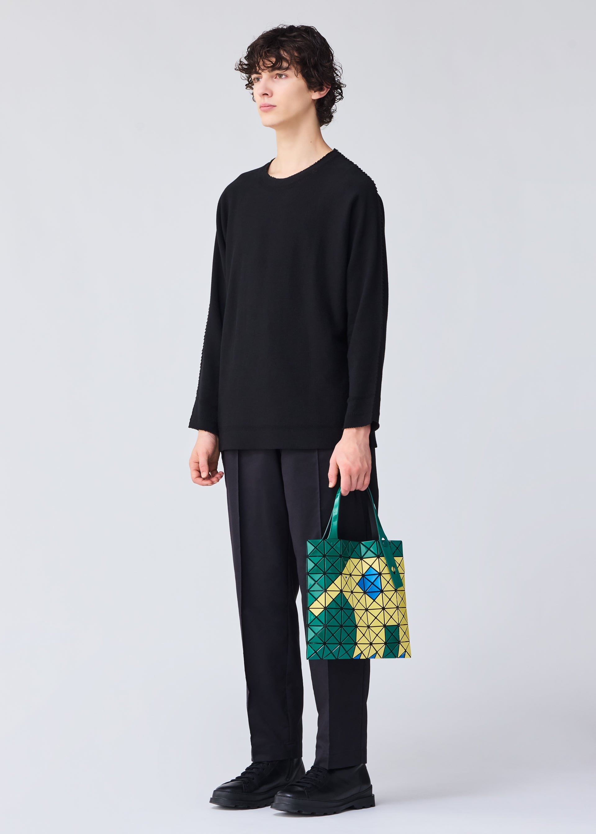 A model wears the Bao Bao Issey Miyake WONDER tote bag.