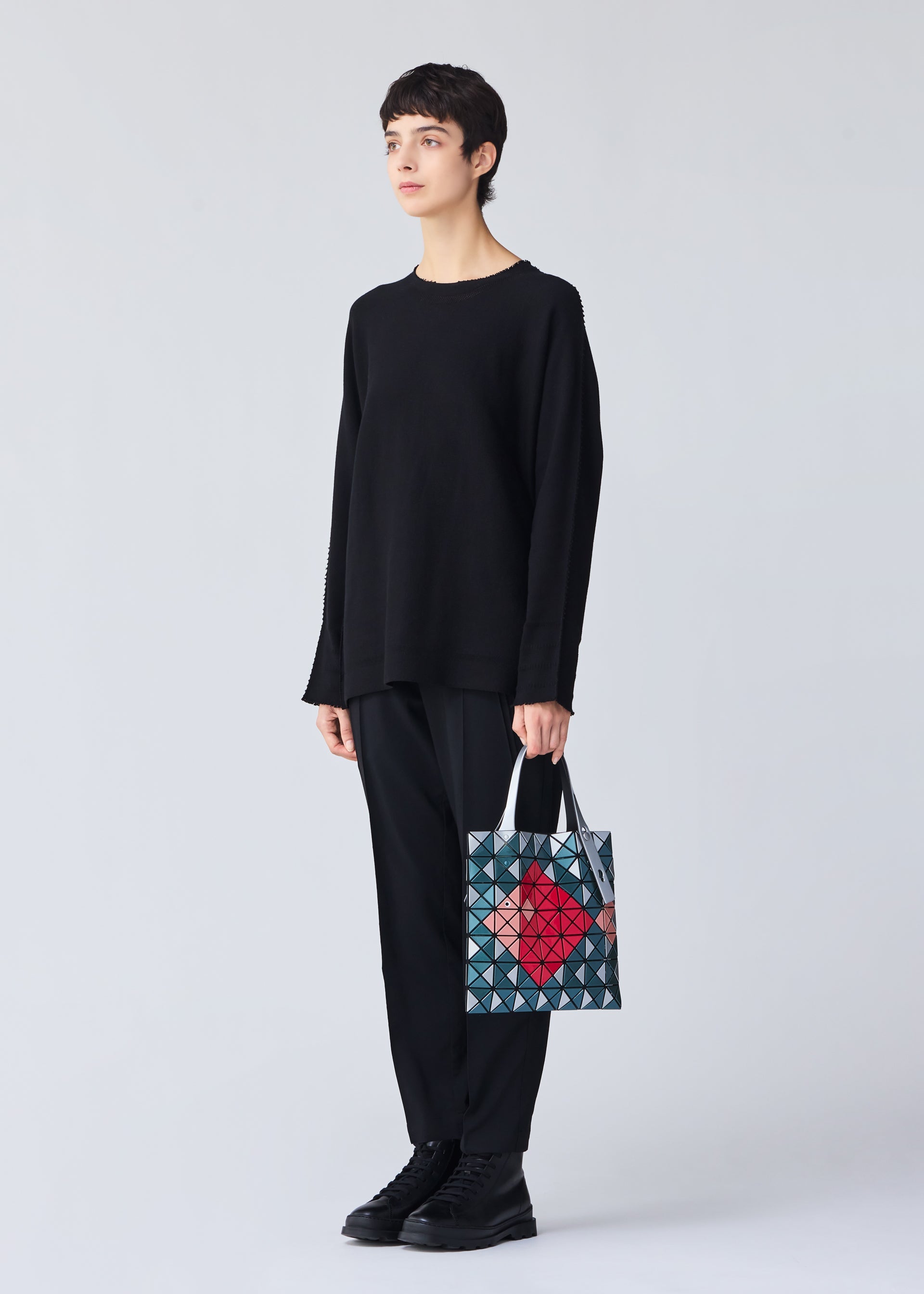 A model wears the Bao Bao Issey Miyake WONDER tote bag.