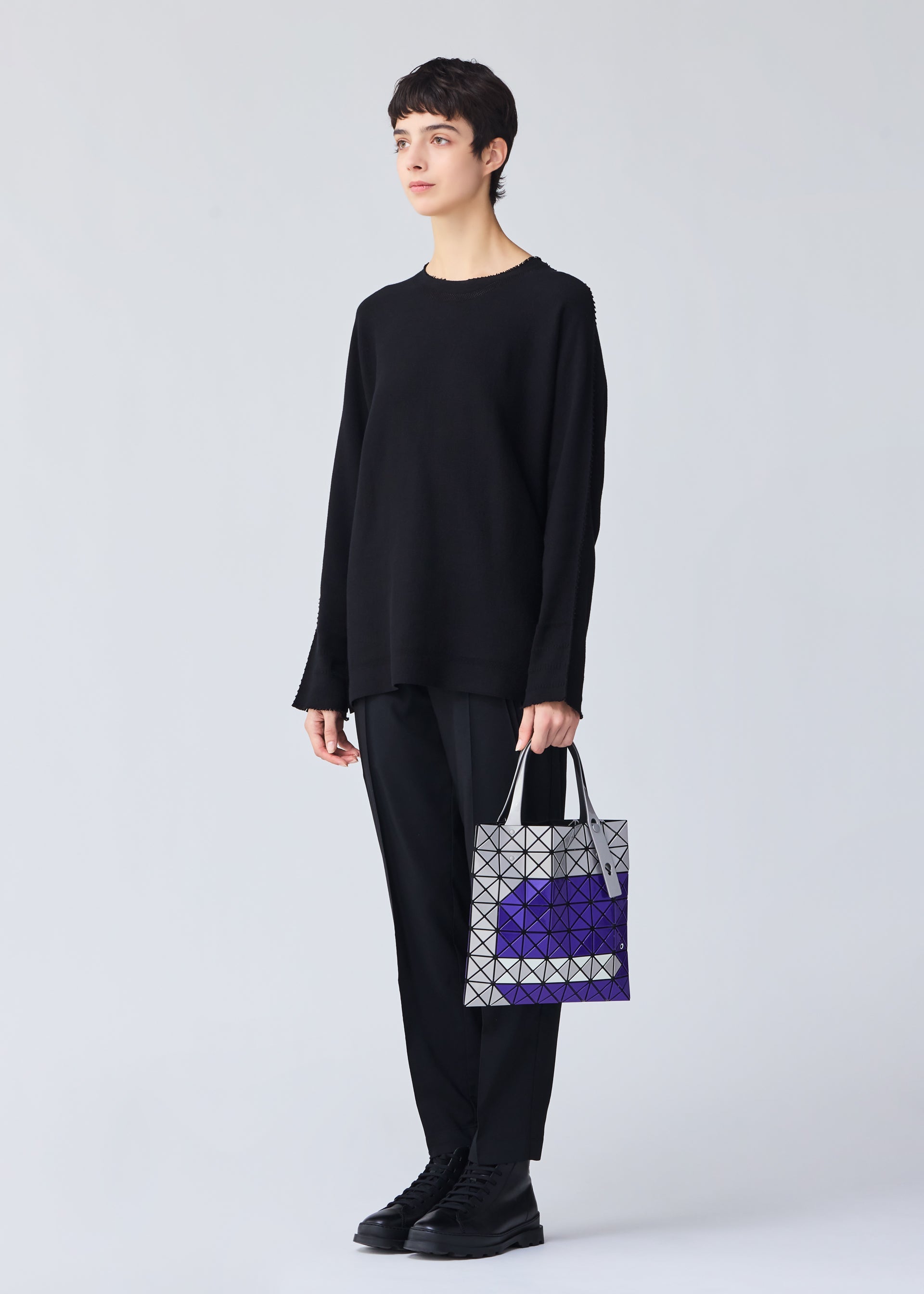 A model wears the Bao Bao Issey Miyake WONDER tote bag.