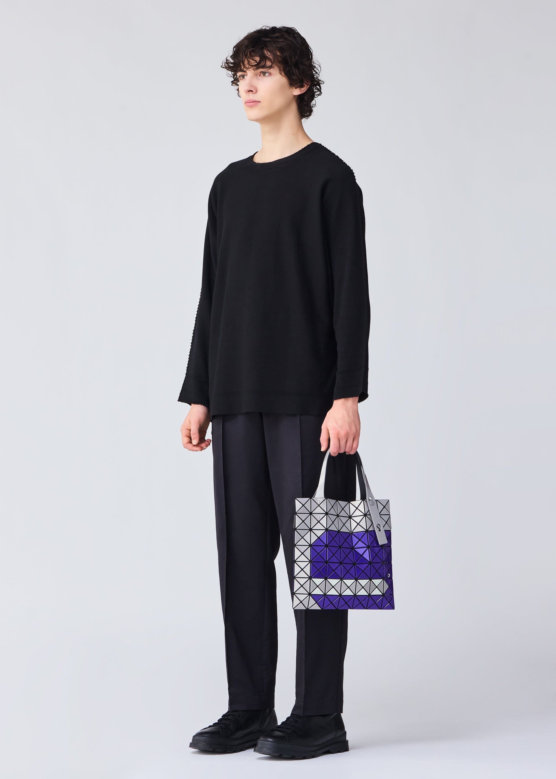 A model wears the Bao Bao Issey Miyake WONDER tote bag.