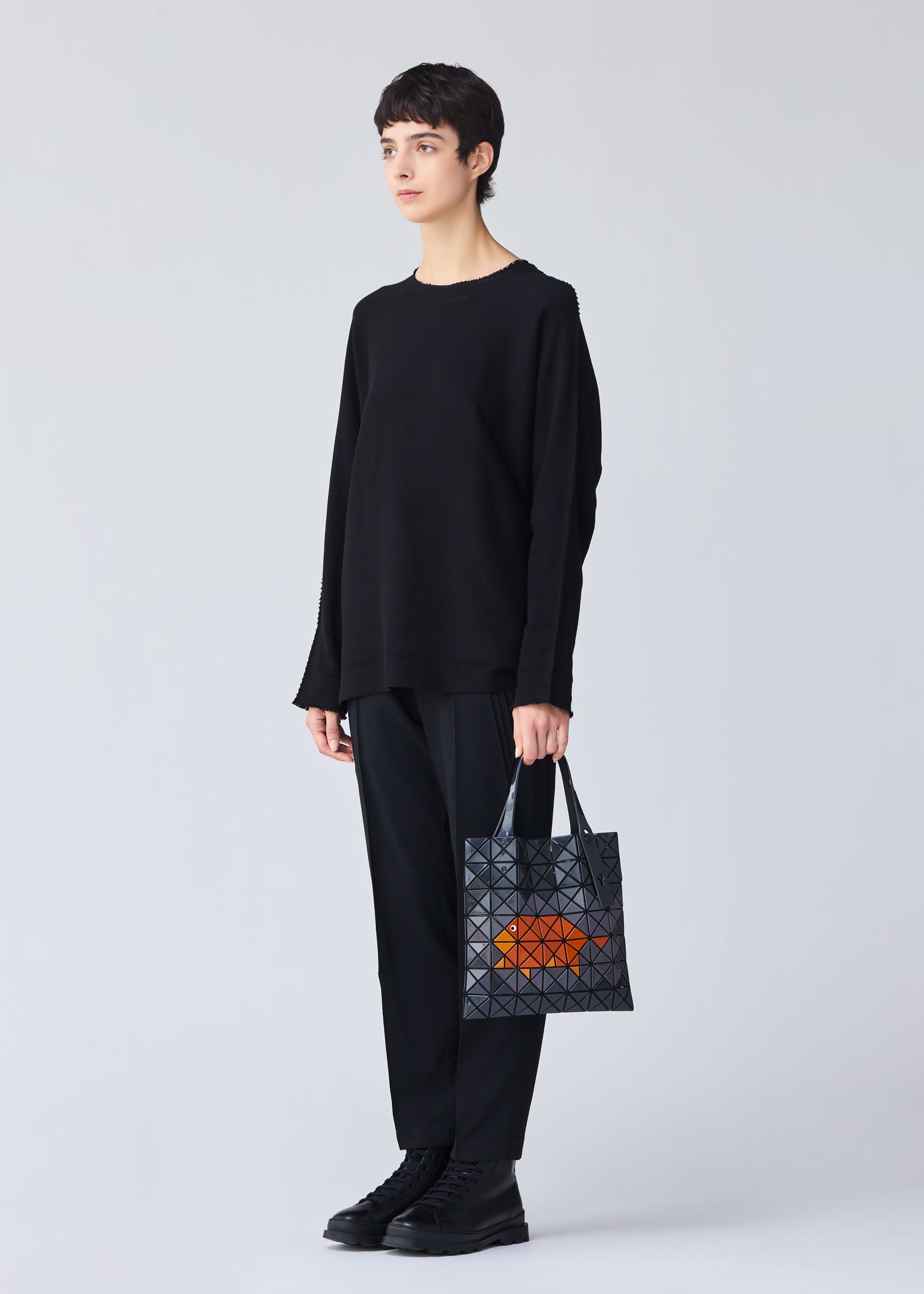 A model wears the Bao Bao Issey Miyake WONDER tote bag.