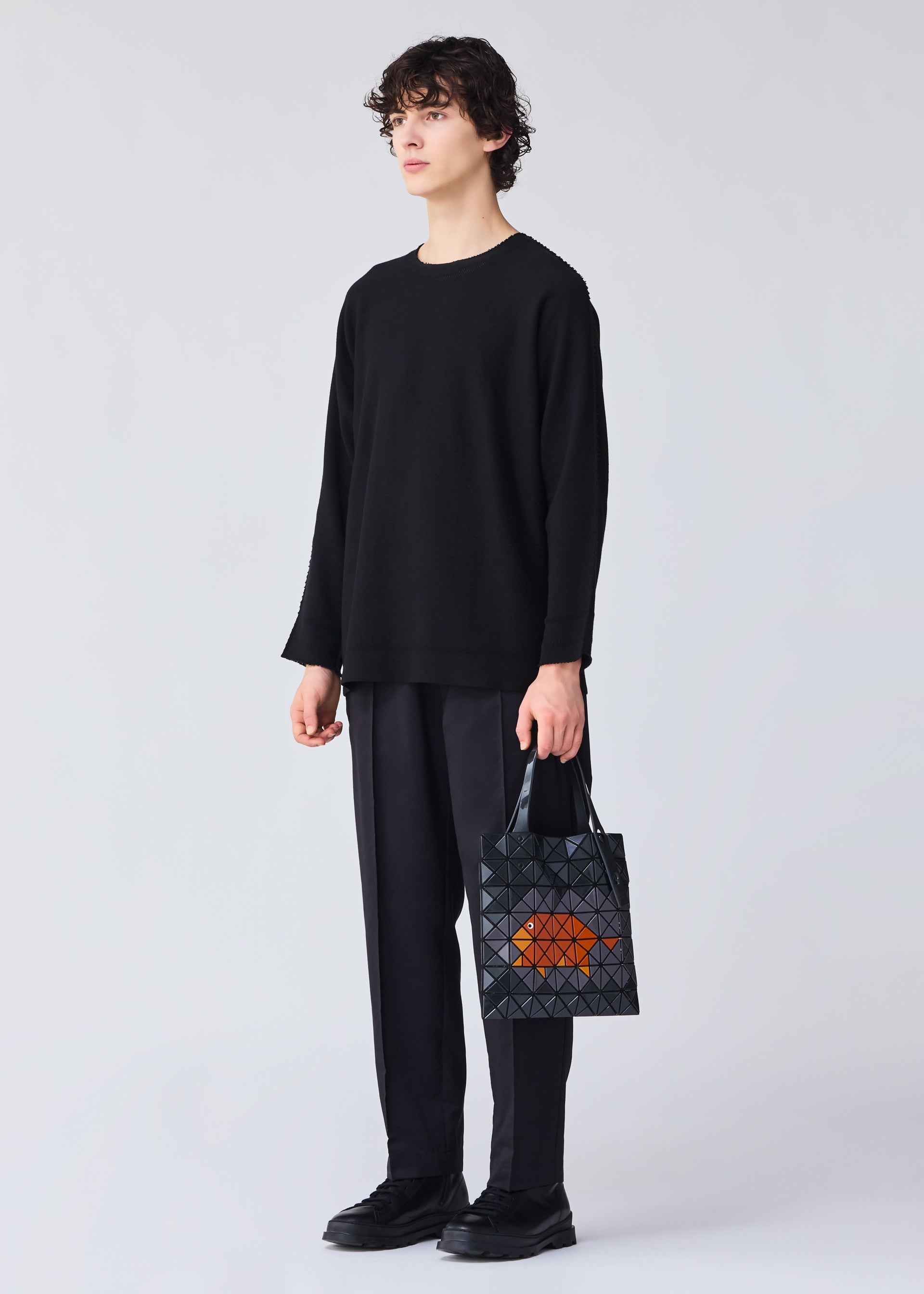 A model wears the Bao Bao Issey Miyake WONDER tote bag.