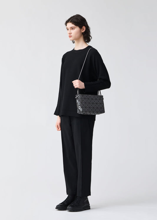 A model wears the BAOBAO ISSEY MIYAKE LOOP ONE TONE shoulder bag.