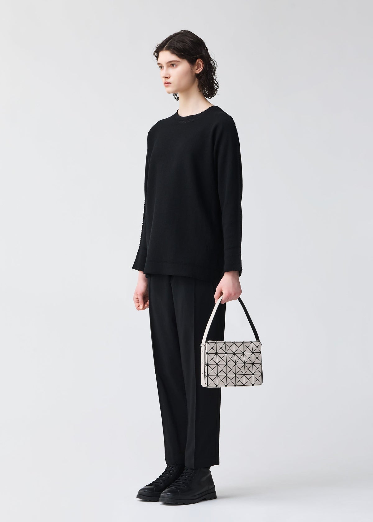 A model wears the BAO BAO ISSEY MIYAKE OBLONG oblong-shoulder-bagsmall-khaki.