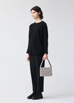 A model wears the BAO BAO ISSEY MIYAKE OBLONG oblong-shoulder-bagsmall-khaki.