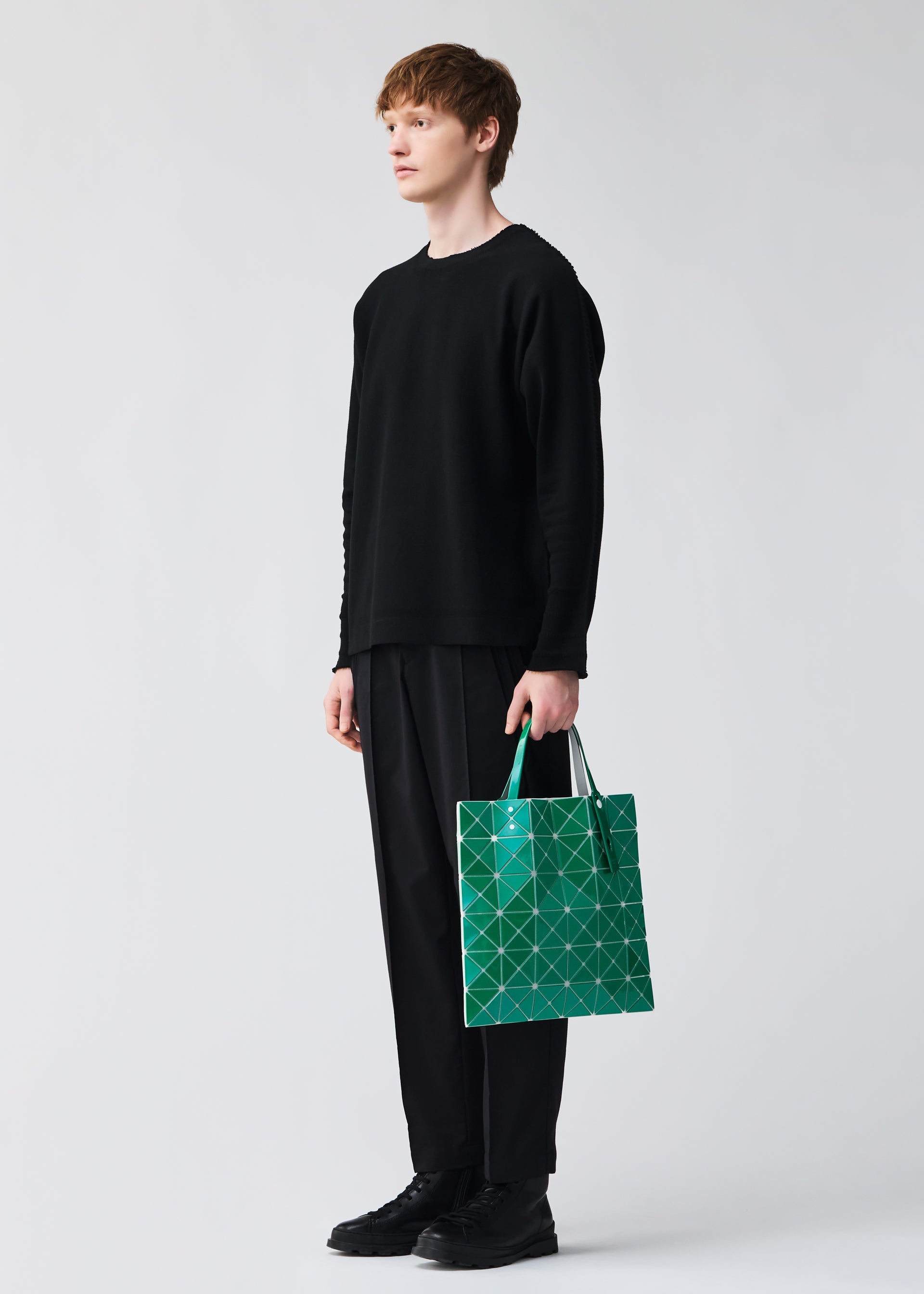 A model wears the BAOBAO ISSEY MIYAKE LUCENT FLAP tote bag(6*6).