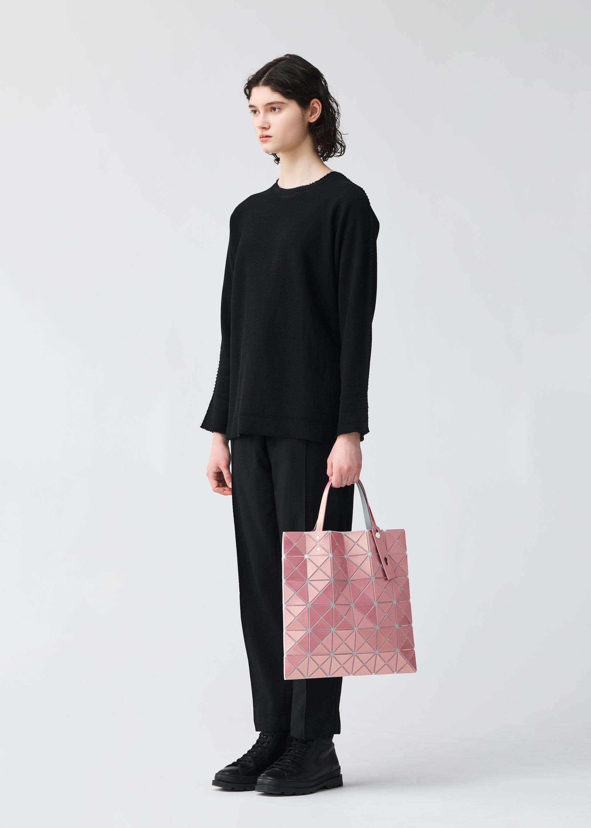 A model wears the BAOBAO ISSEY MIYAKE LUCENT FLAP tote bag(6*6).