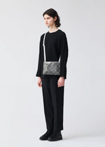 A model wears the BAOBAO ISSEY MIYAKE LUCENT FLAP shoulder bag(3*4).