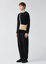 A model wears the BAOBAO ISSEY MIYAKE LUCENT FLAP shoulder bag(3*4).