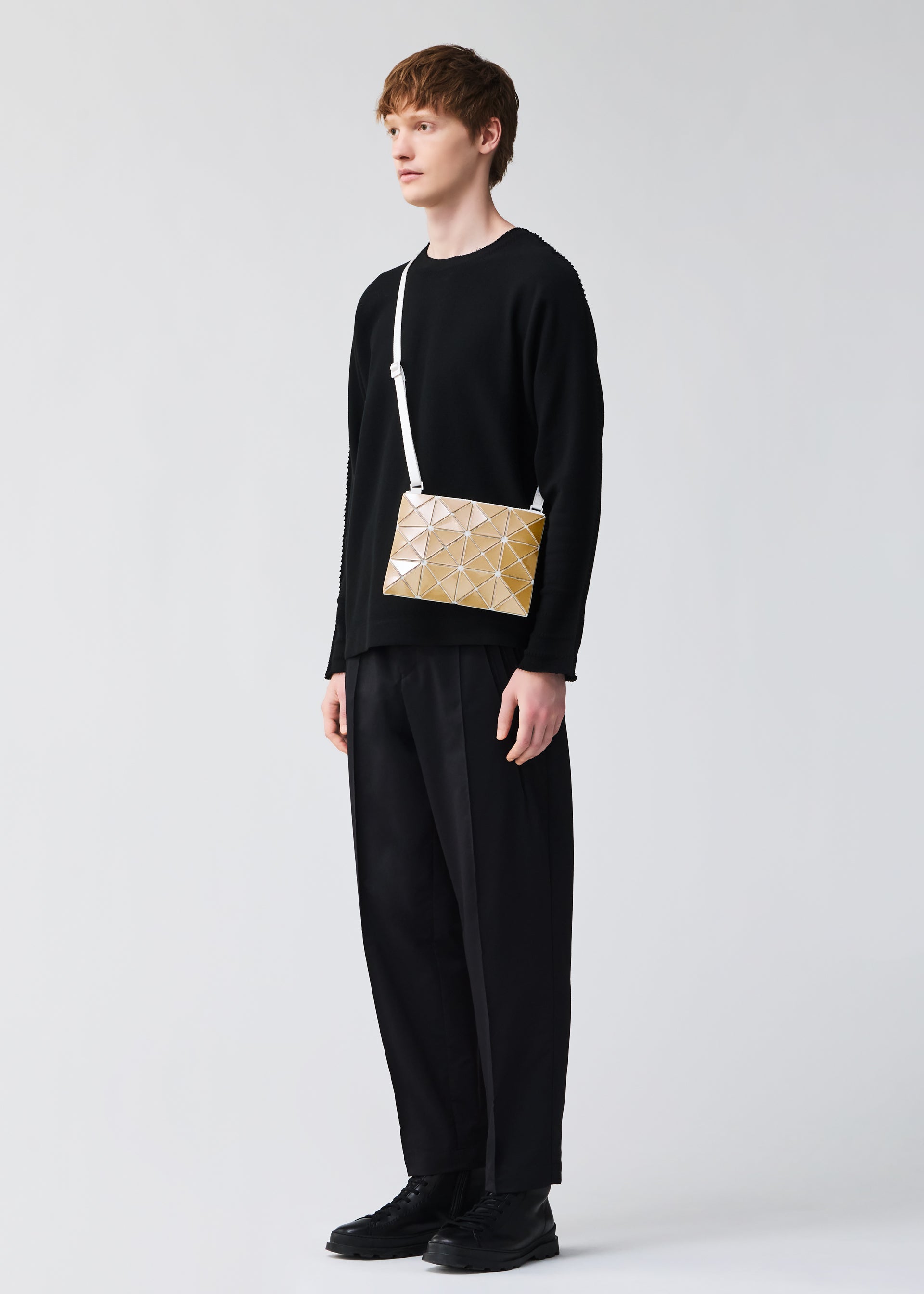 A model wears the BAOBAO ISSEY MIYAKE LUCENT FLAP shoulder bag(3*4).
