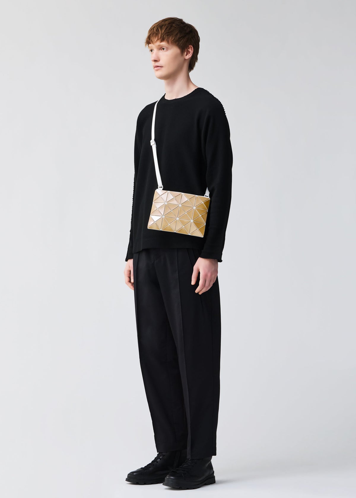 A model wears the BAOBAO ISSEY MIYAKE LUCENT FLAP shoulder bag(3*4).