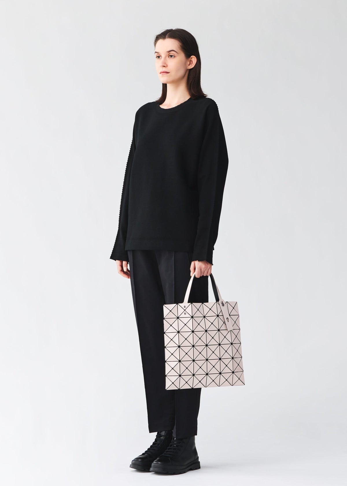 A model wears the BAO BAO ISSEY MIYAKE LUCENT lucent-basics-tote-bag6-6-black.