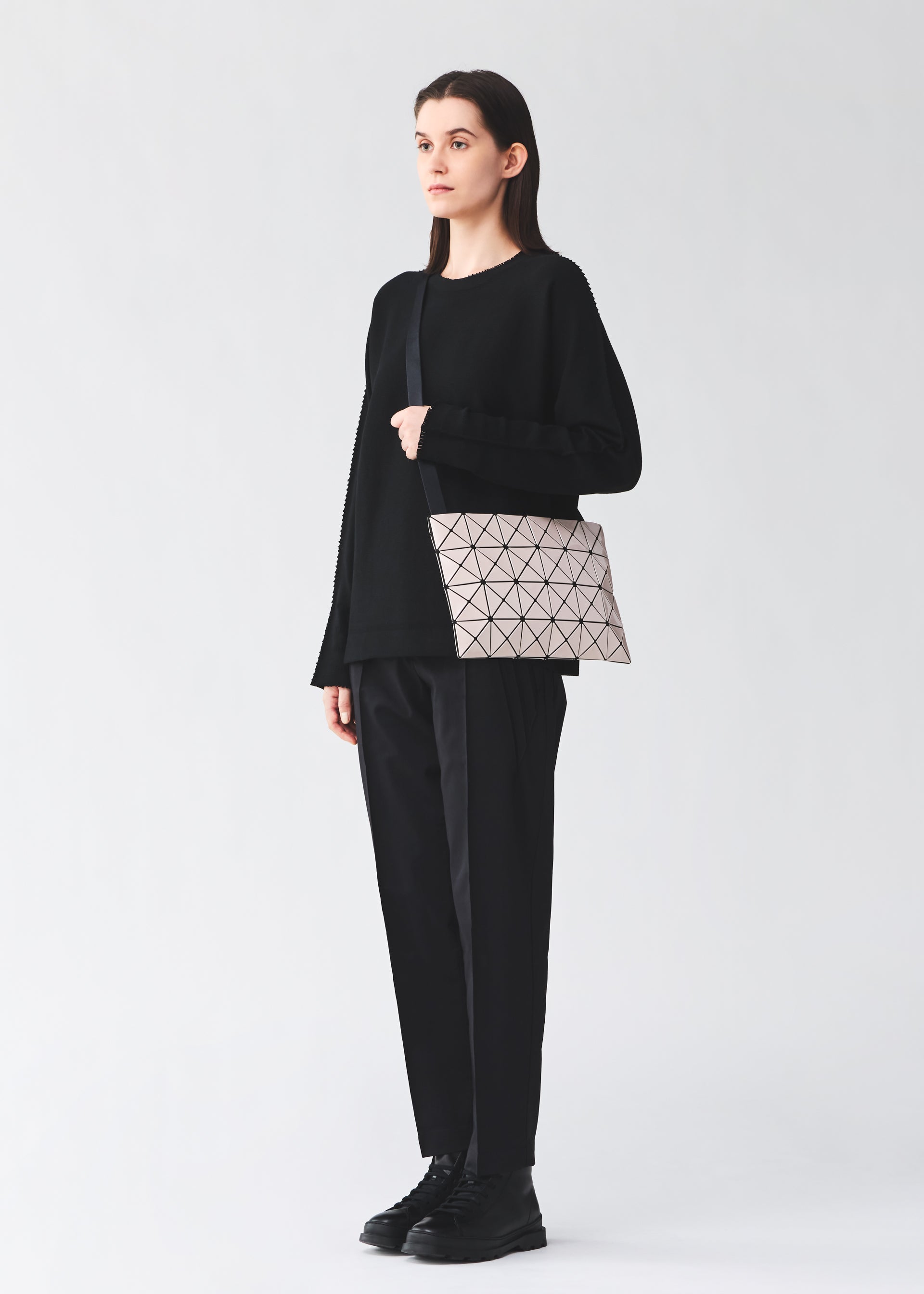 A model wears the BAO BAO ISSEY MIYAKE LUCENT lucent-basics-shoulder-bag4-6-white-1.