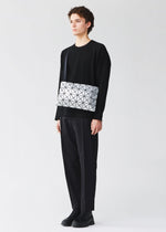 A model wears the BAO BAO ISSEY MIYAKE LUCENT lucent-basics-shoulder-bag4-6-white-1.