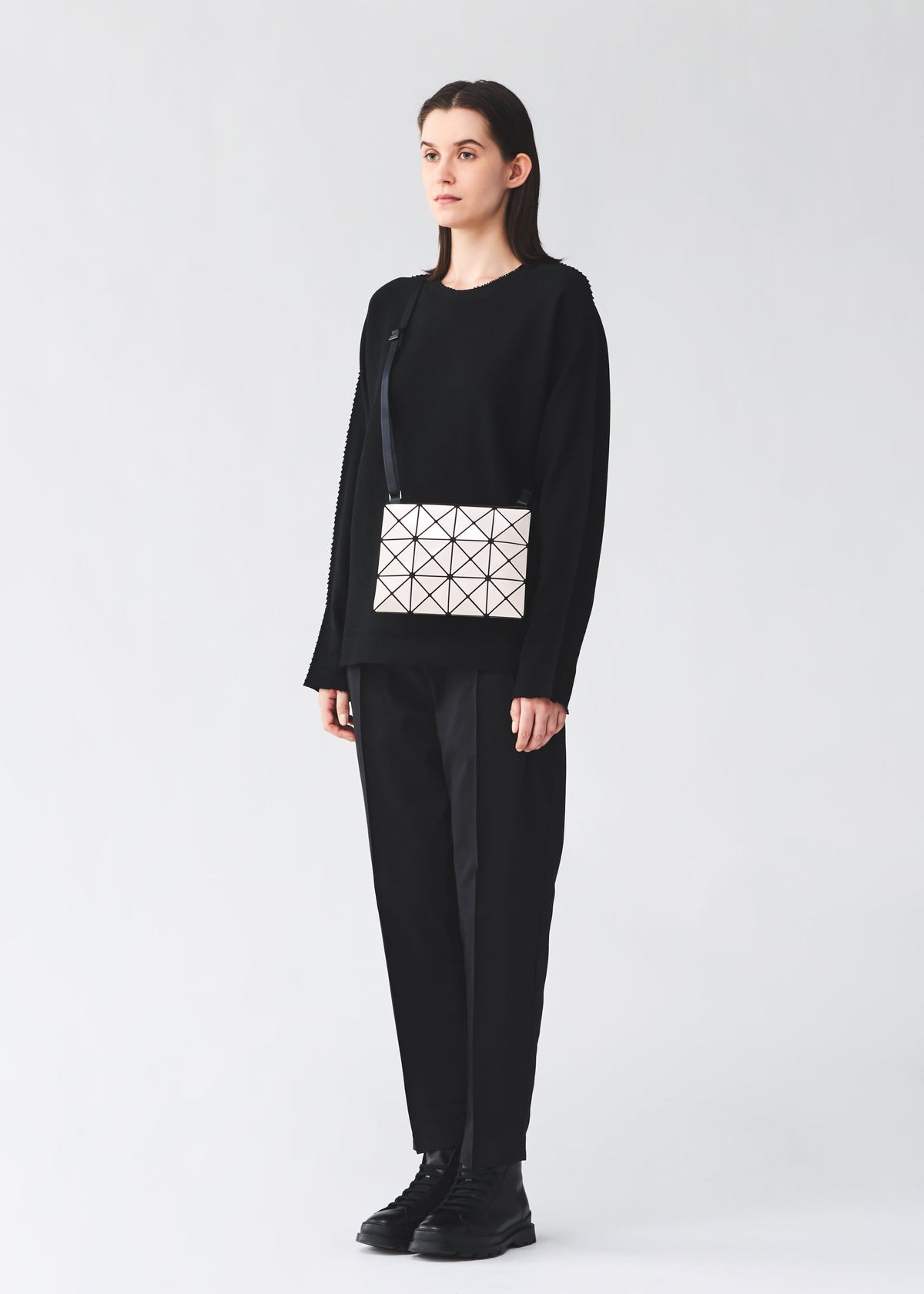 A model wears the BAO BAO ISSEY MIYAKE LUCENT lucent-basics-shoulder-bag3-4-black.
