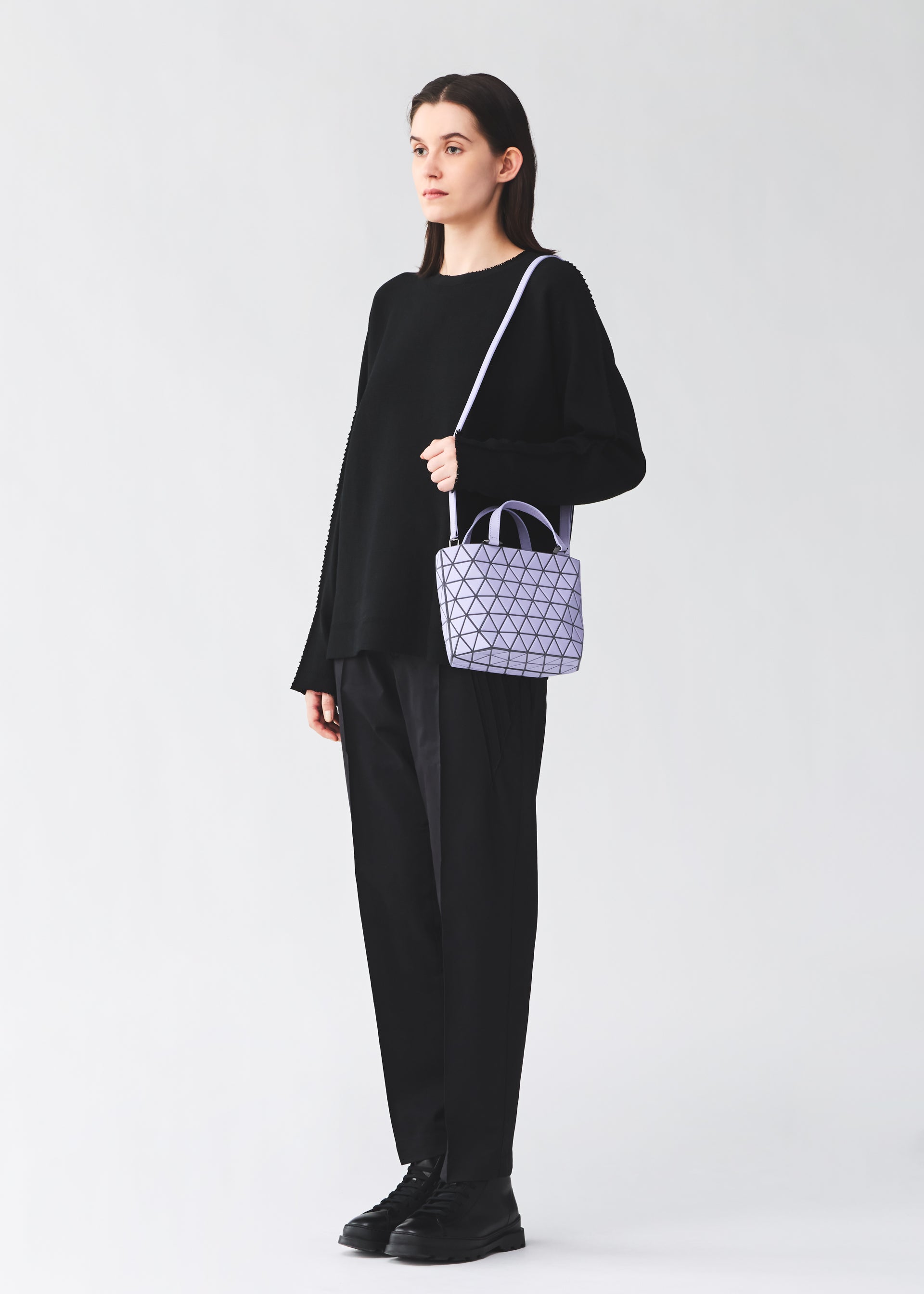 A model wears the BAO BAO ISSEY MIYAKE CRYSTAL MATTE hand bag.