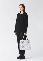 A model wears the BAO BAO ISSEY MIYAKE CARTON carton-hand-bag-black-1-fw26.