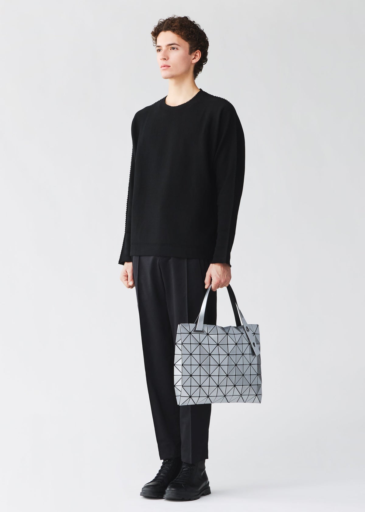 A model wears the BAO BAO ISSEY MIYAKE CARTON carton-hand-bag-black-1-fw26.