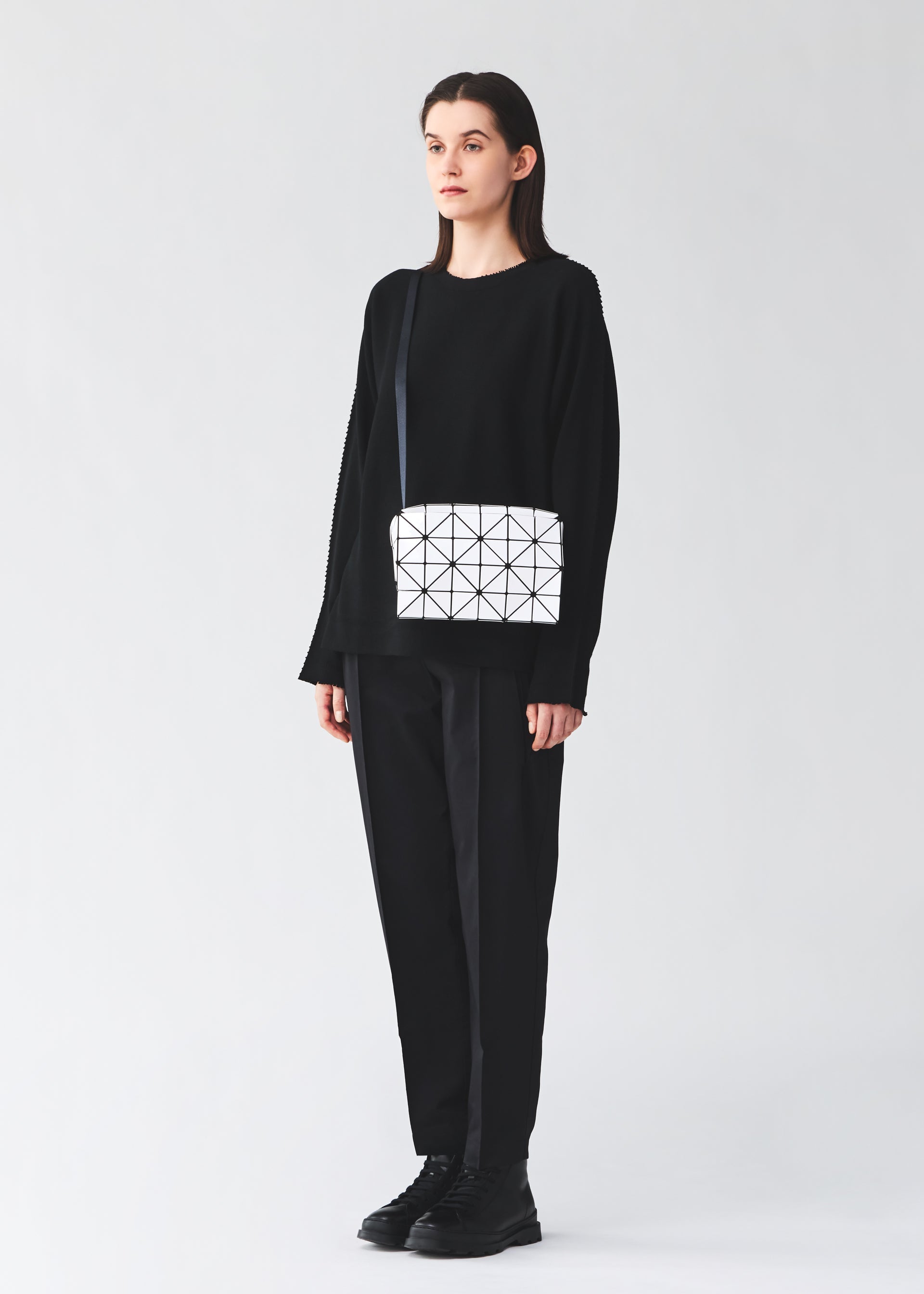 A model wears the BAO BAO ISSEY MIYAKE CARTON carton-shoulder-bag-black-fw26.