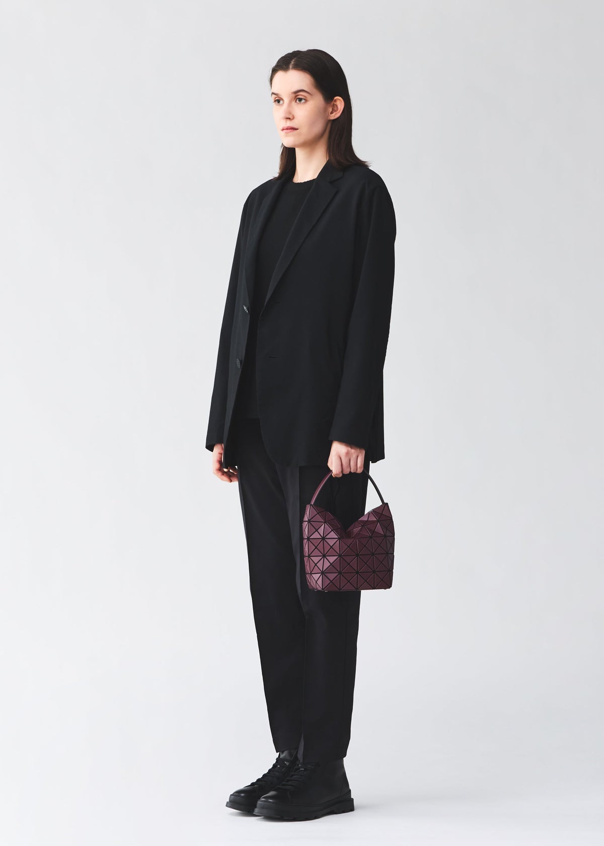 A model wears the BAO BAO ISSEY MIYAKE VALLEY hand bag.