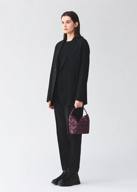 A model wears the BAO BAO ISSEY MIYAKE VALLEY hand bag.