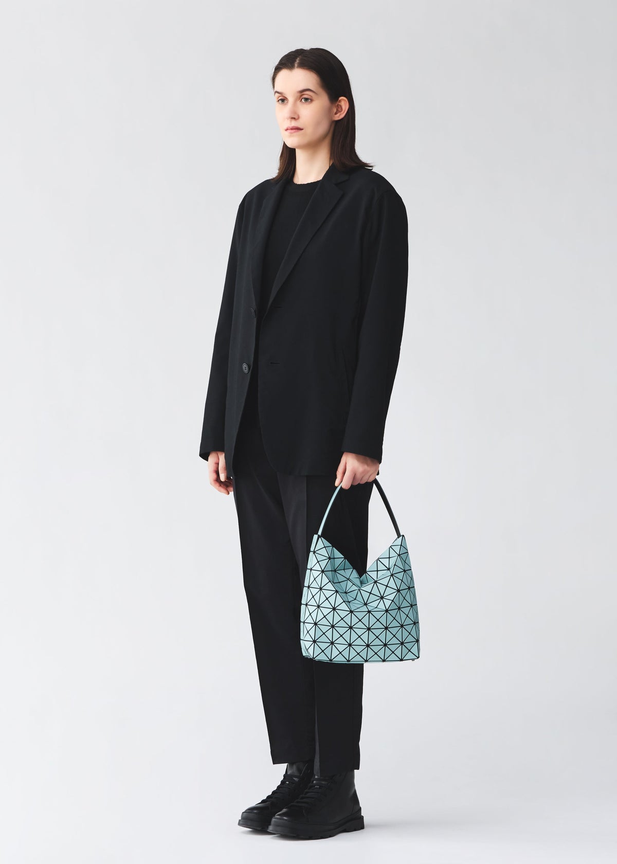 A model wears the BAO BAO ISSEY MIYAKE VALLEY hand bag.