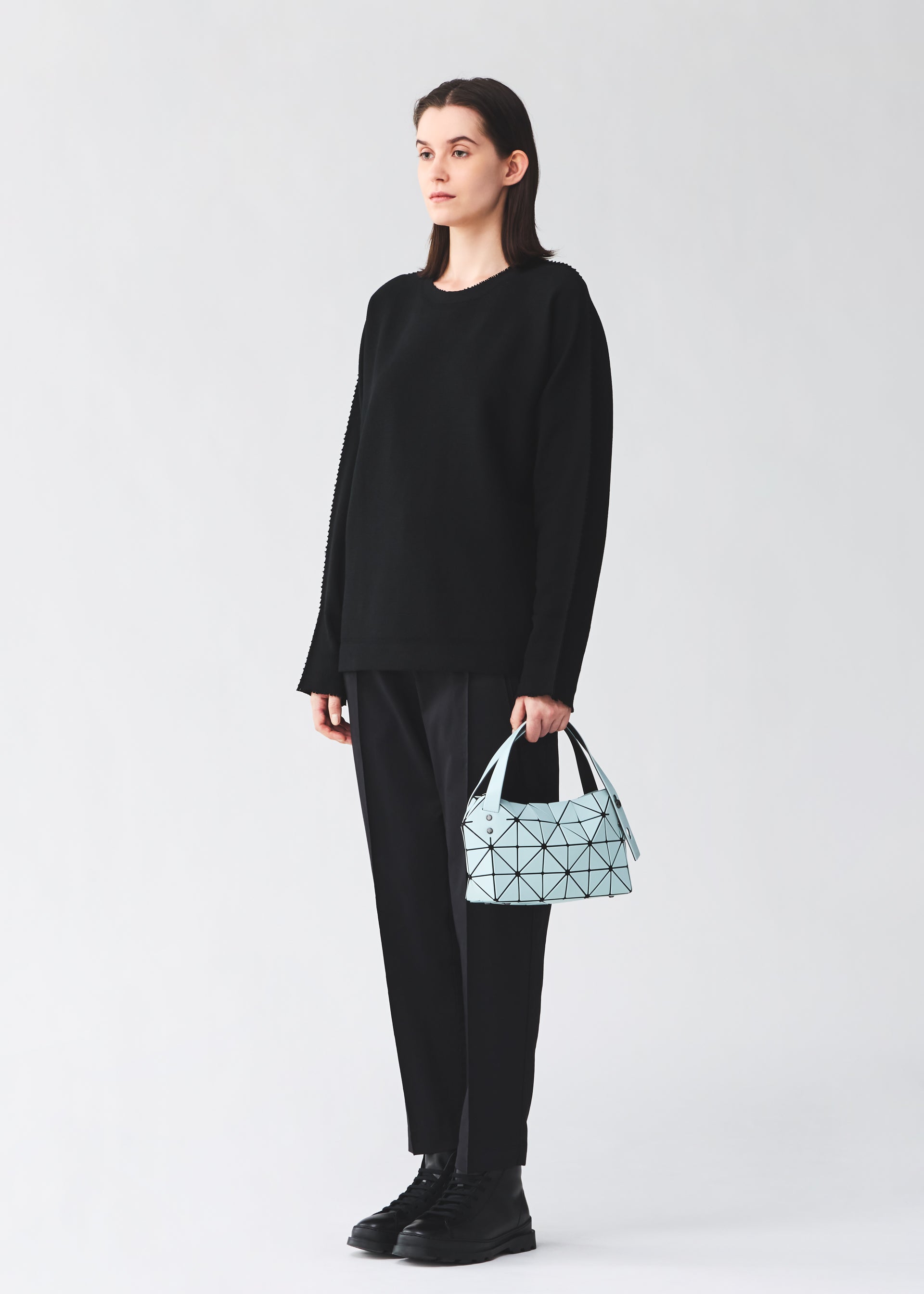 A model wears the BAO BAO ISSEY MIYAKE BOSTON boston-handbag-off-white.