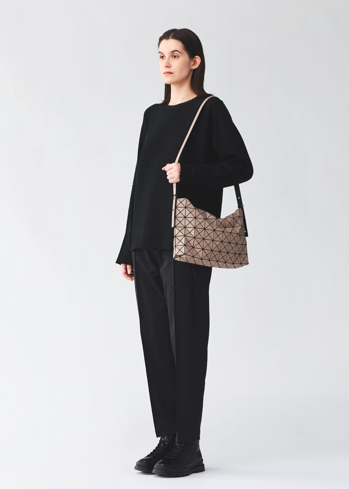 A model wears the BAO BAO ISSEY MIYAKE MUSETTE musette-shoulder-baglarge-light-grey.